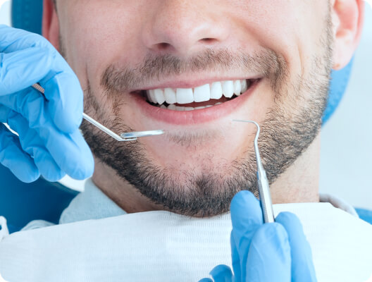 dentist using special tools on patient's smile