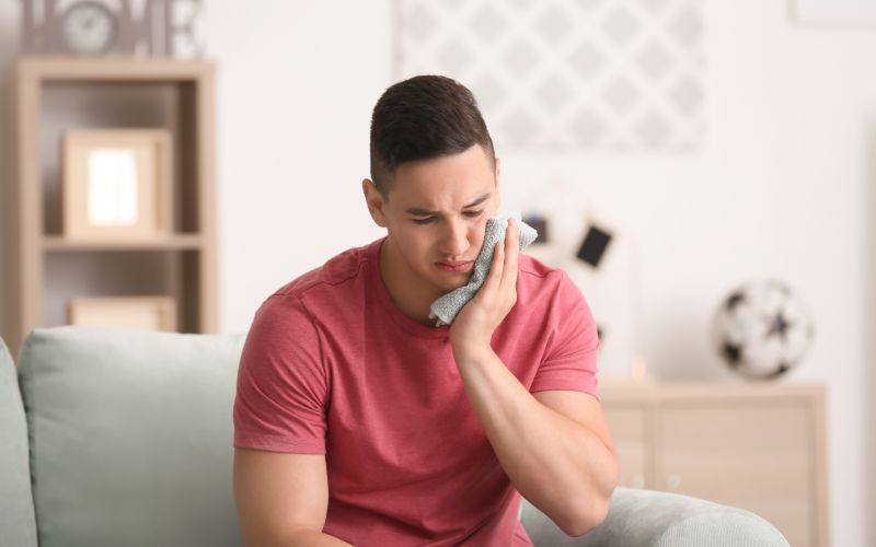 man holding a compress to his jaw