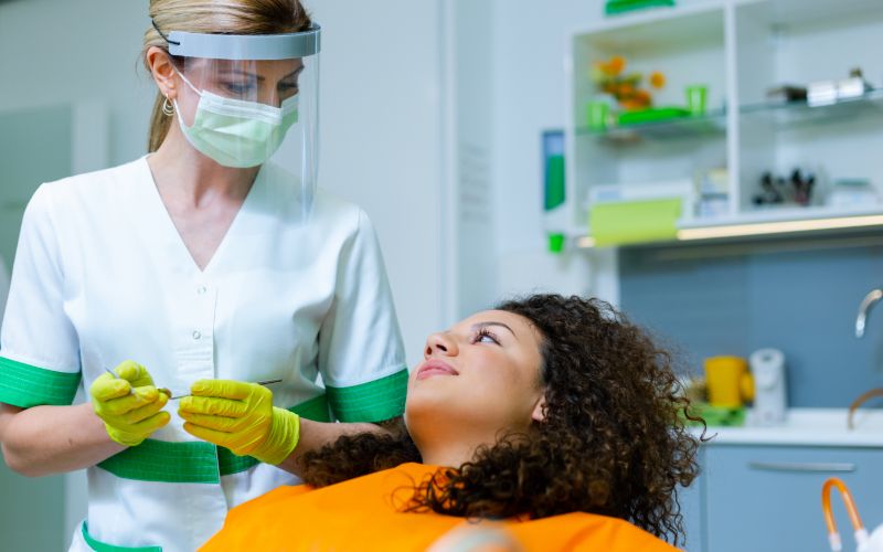 woman sitting back in a dental chair