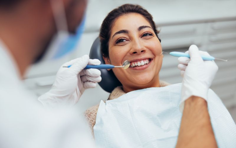 woman getting her teeth examined at the dentist