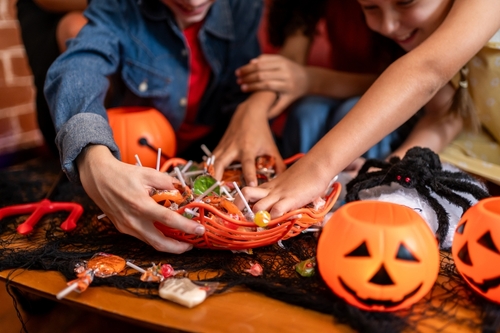 children reaching for candy