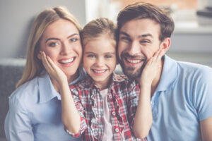Portrait,Of,Beautiful,Young,Parents,And,Their,Cute,Little,Daughter