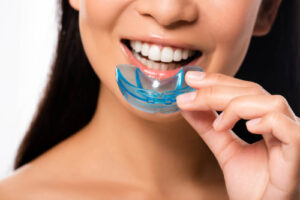Cropped,View,Of,Woman,Using,Mouth,Guard
