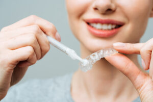 Young,Woman,Does,A,Home,Teeth,Whitening,Procedure